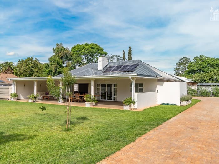 Single-storey home with covered veranda, solar roof and wide lawn