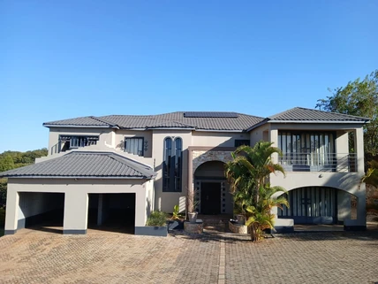 Double-storey contemporary residence with paved forecourt and double garage